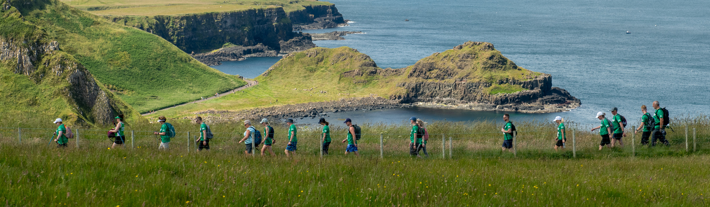 Might Hikers walking across the Giant's Causeway coastline
