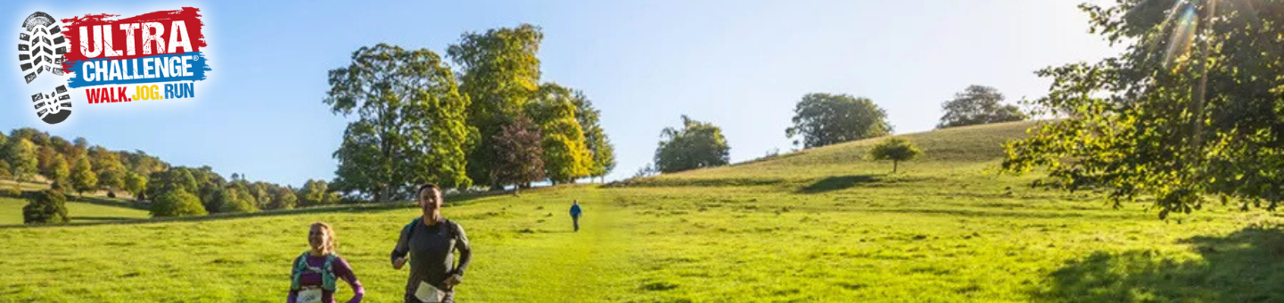 3 people running down a hill in the North Downs Ultra Challenge