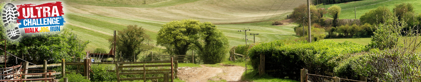 A dirt path through a grassy field.