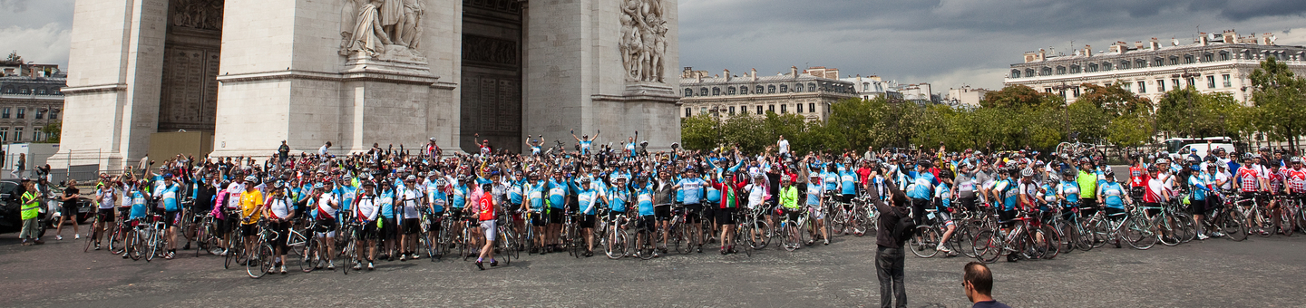 Arc de Triomphe in Paris surrounded by hundreds of cyclists.
