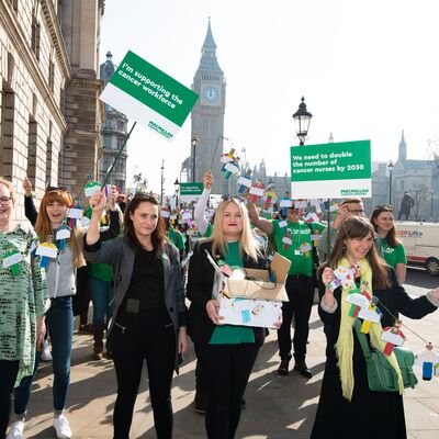 Macmillan campaigners stood in the street holding signs