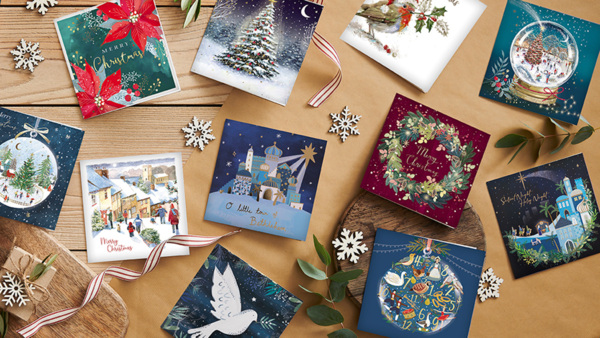A selection of Christmas cards and decorations on a table