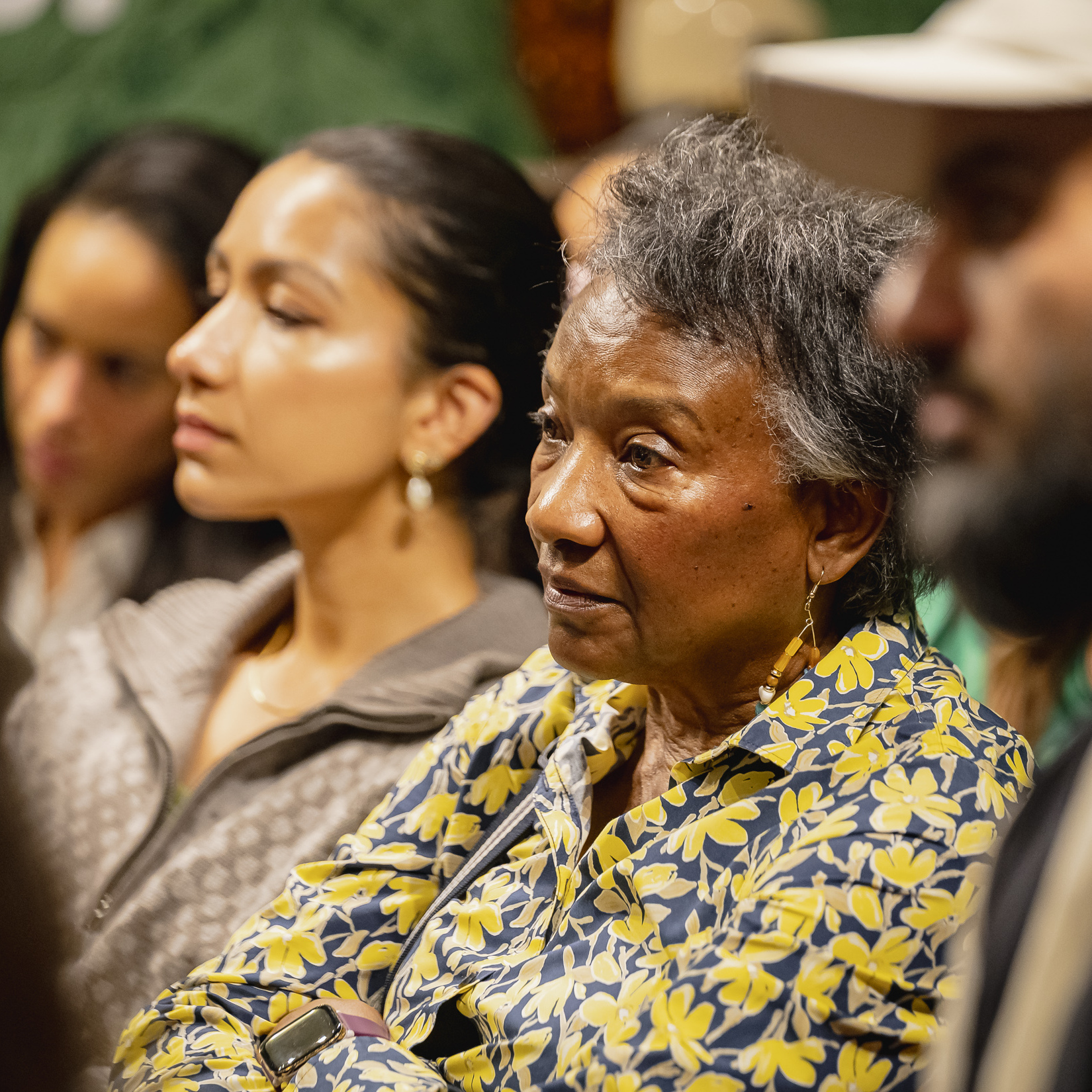 Close-up of attendees listening attentively during a Macmillan Cancer Support Open House discussion