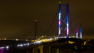 The Forth Bridge lit up at night