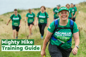 Image of the front cover of the training guide with Mighty Hikers walking on a grassy cliff near the coast