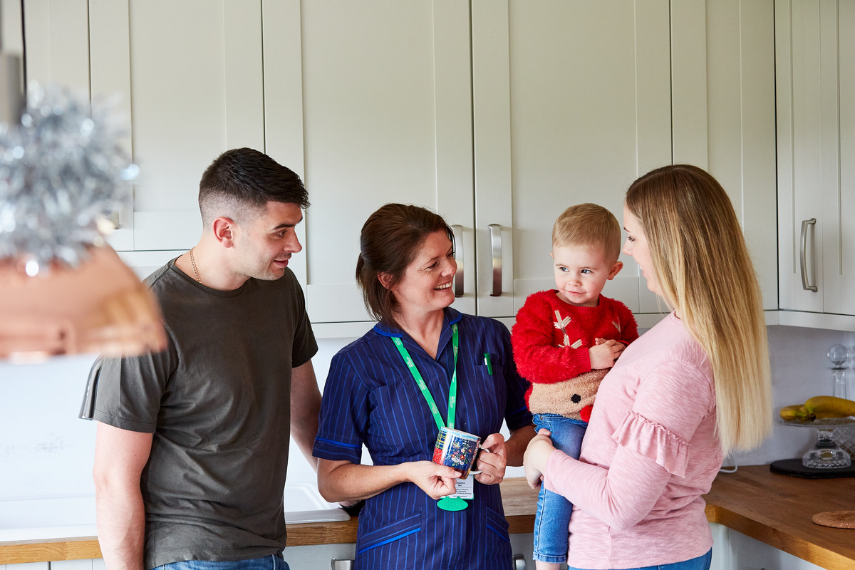 Macmillan Nurse talks to Katie and her family at their home