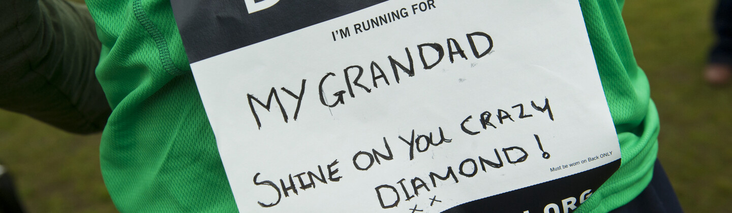 A green Macmillan running shirt with a handwritten dedication on the back saying I'm running for my grandad, shine on you crazy diamond!