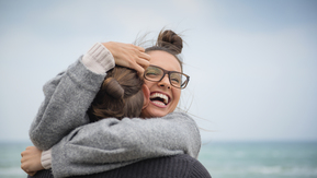 A photo of two people hugging. 