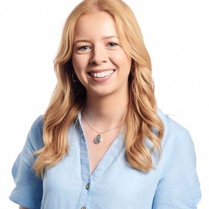 Head-and-shoulders portrait of a person wearing a light blue shirt against a white background.