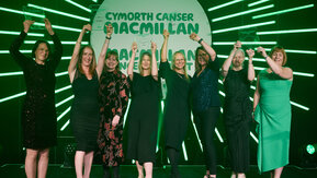 8 people holding up their Macmillan Professional Awards