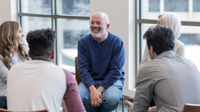 Group of people sat in a circle in discussion