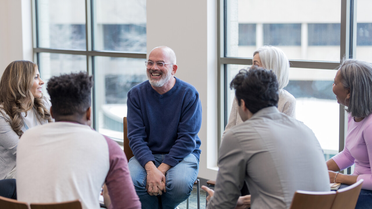Group of people sat in a circle in discussion