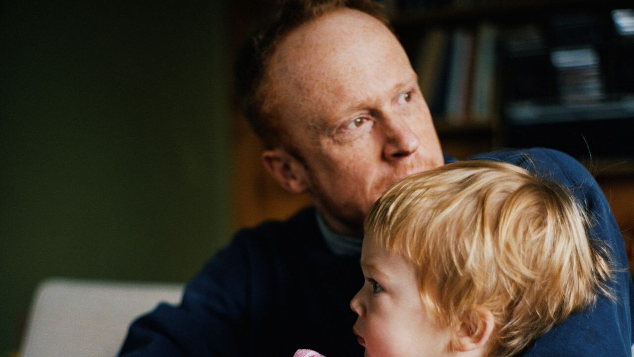 Father holding his toddler son