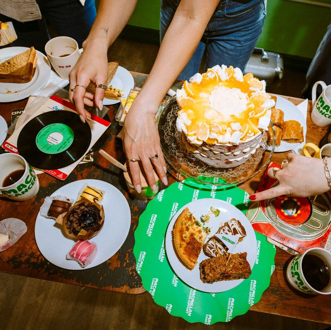 Table full of cakes, drinks and savoury treats
