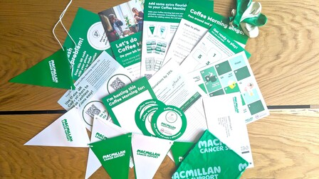 A photo of the Coffee Morning full fundraising kit. It includes a preview of all the different items you will get in your kit such as bunting, balloons, a table cloth,  and more!