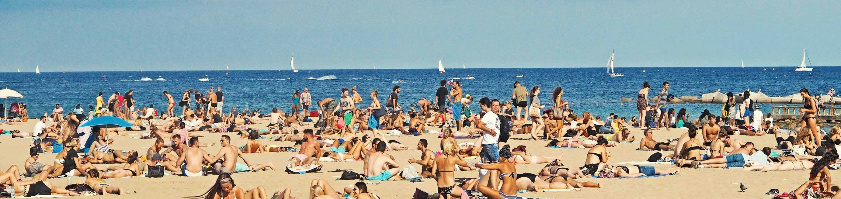 Lots of people on a busy beach
