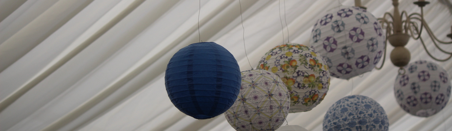 A photo of paper pom poms used a decorations for a Mamma Mia fundraising event.