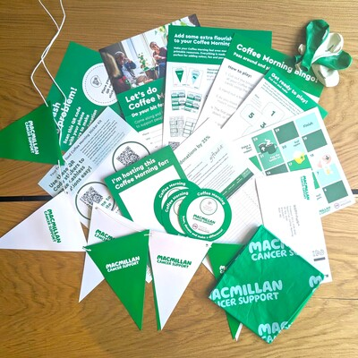 A photo of the Coffee Morning full fundraising kit. It includes a preview of all the different items you will get in your kit such as bunting, balloons, a table cloth,  and more!