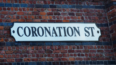 Coronation Street sign on a wall
