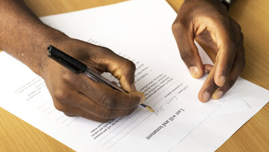 A man signing a form