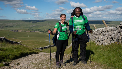 Two Mighty Hikers with walking poles at the top of a hill