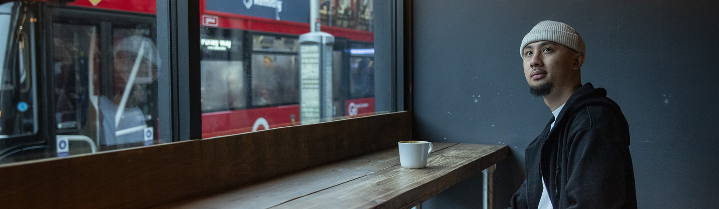 LJ sitting in the window of a coffee shop