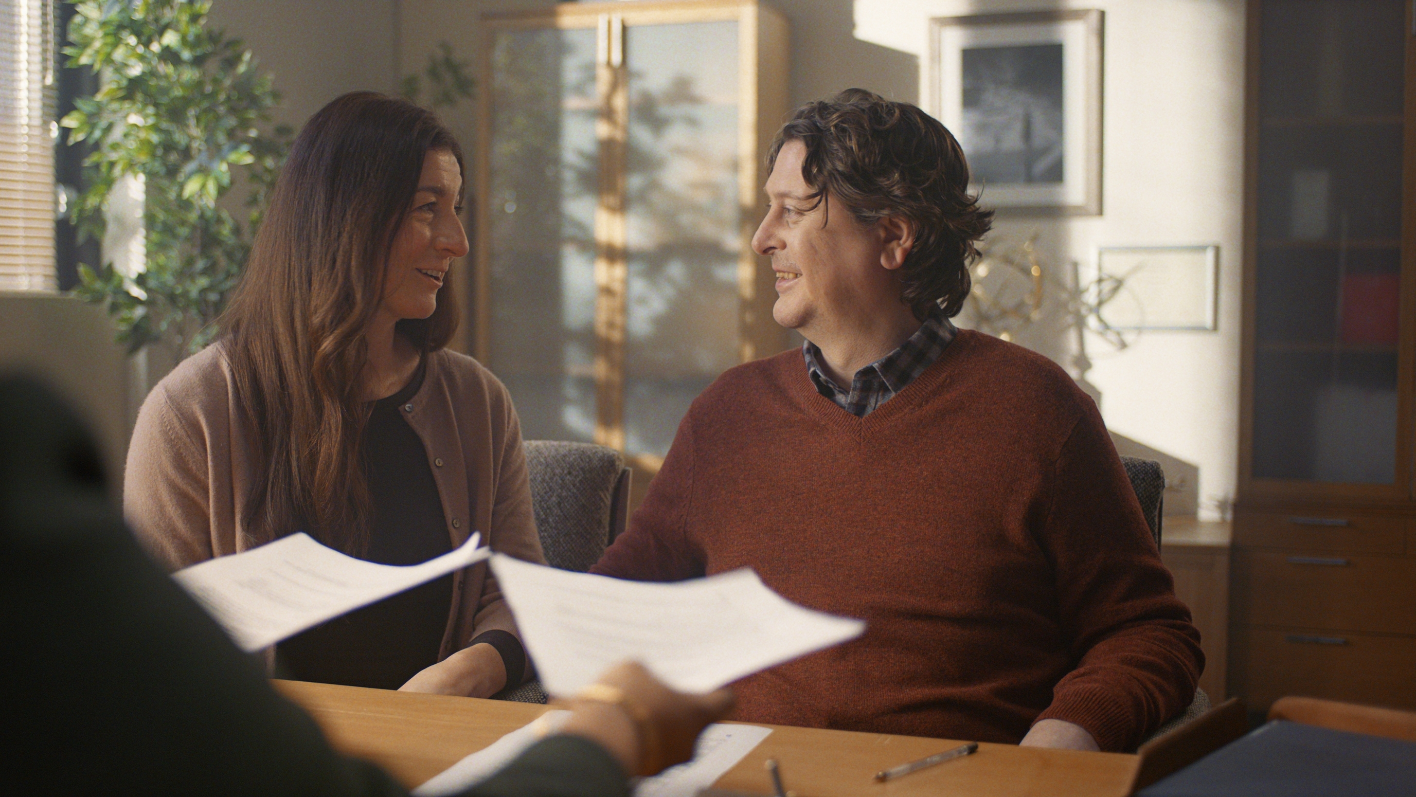 A couple look at eachother smiling.