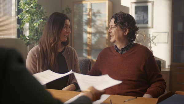 A couple look at eachother smiling.