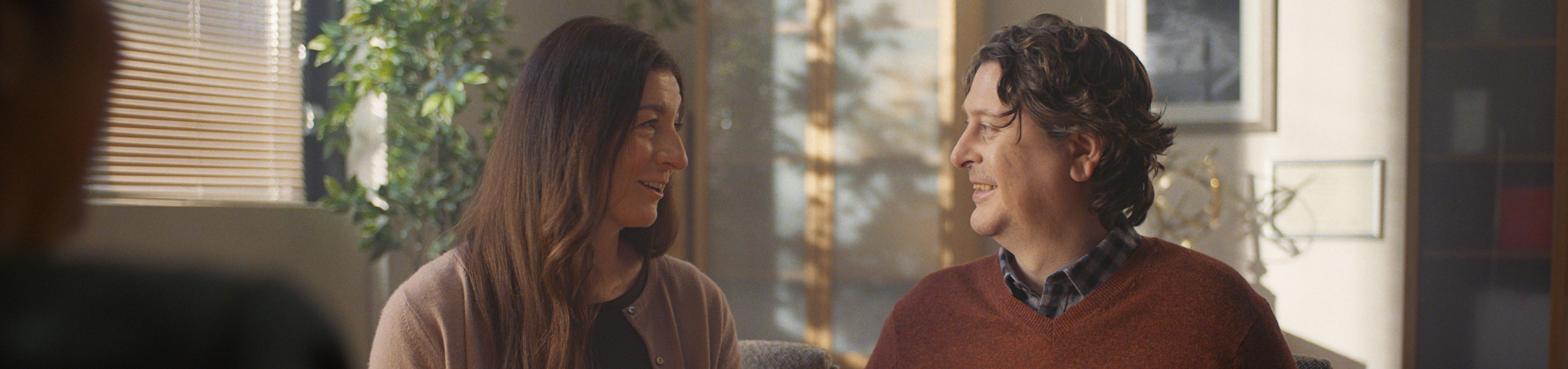 A couple look at eachother smiling.