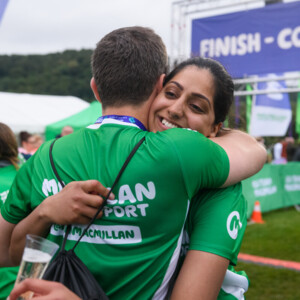 A woman hugging a man at an outdoor fundraising event.
