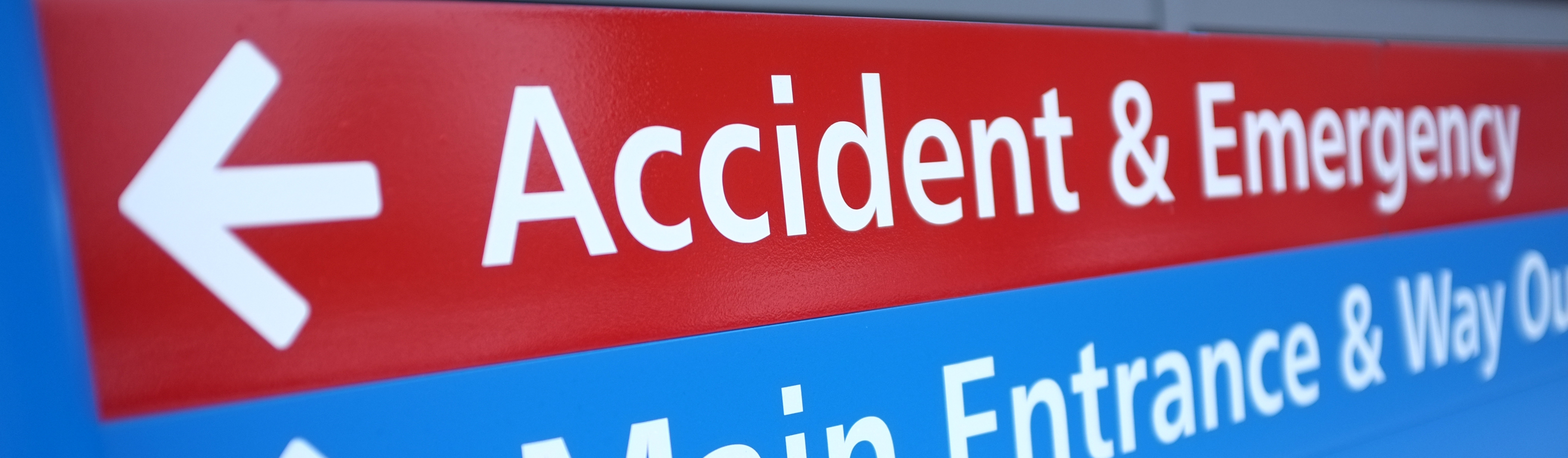 An A&E sign showing which departments are in which direction