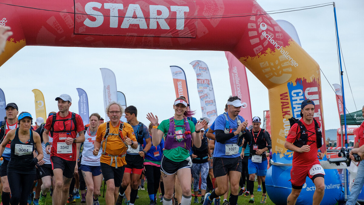A large group of people setting off at the starting line of an ultra challenge.