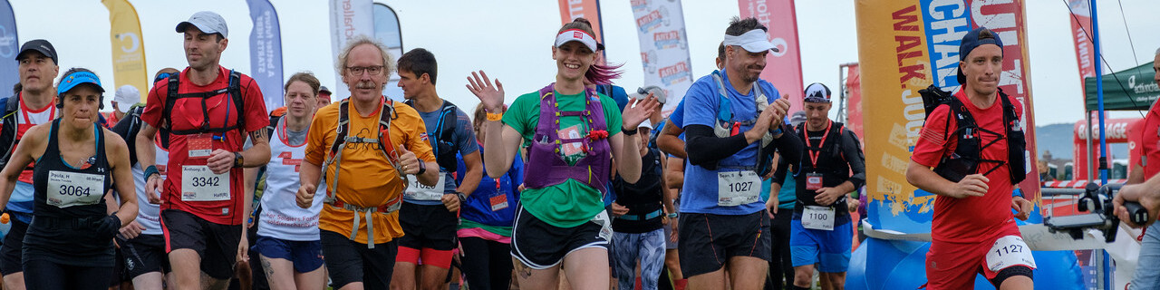 A large group of people setting off at the starting line of an ultra challenge.