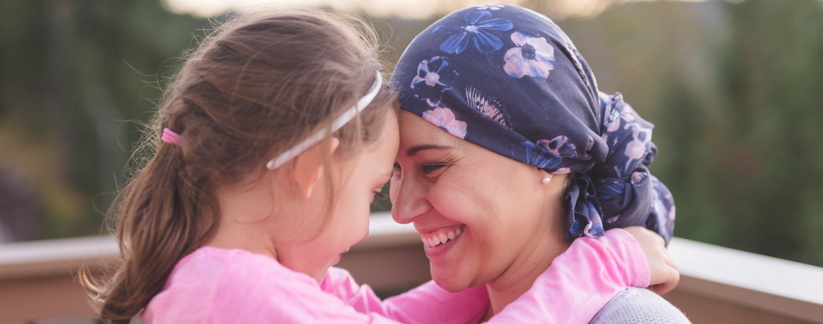A woman wearing a headscarf with her daughter