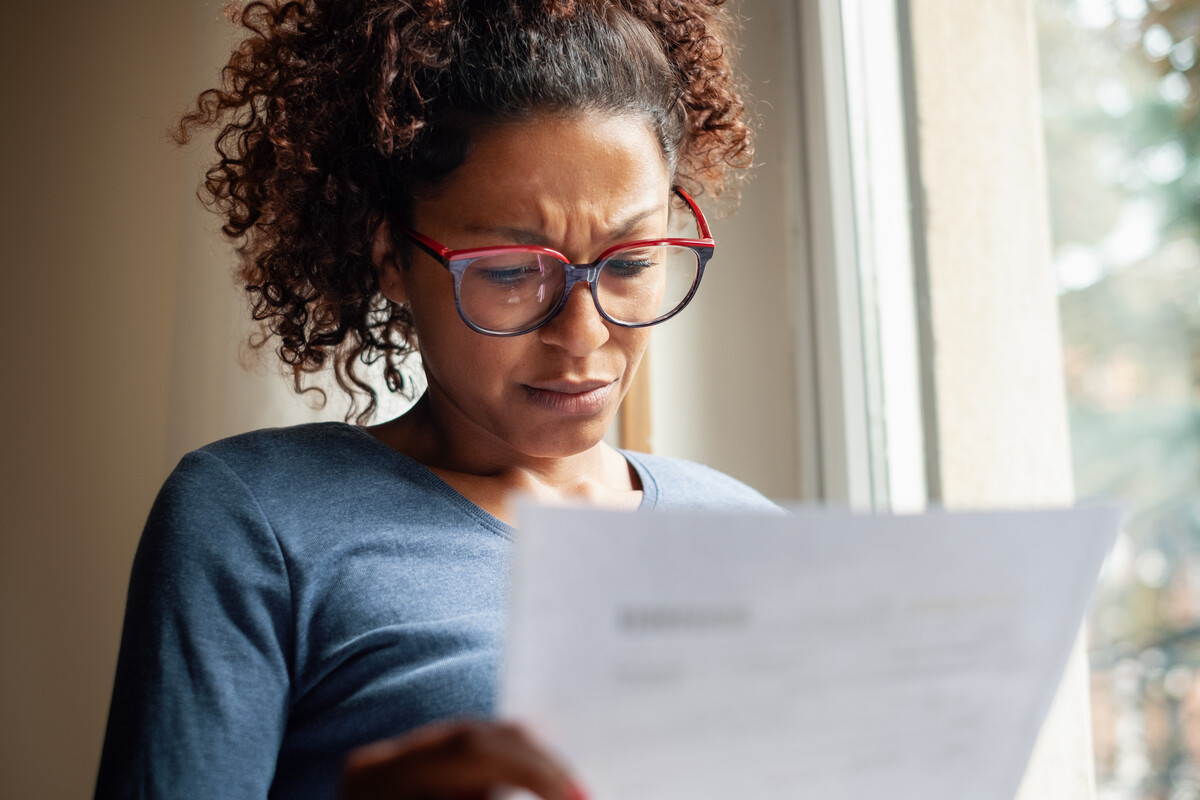 Woman looking at piece of paper