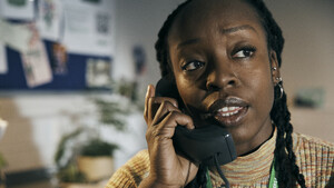 A person holding a telephone receiver.