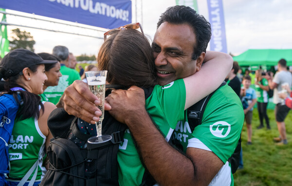 A man and woman hugging after a Macmillan Mighty Hike