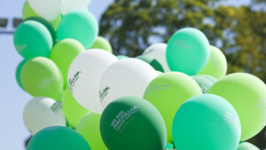 A large bunch of Macmillan balloons strung up at an outdoor event