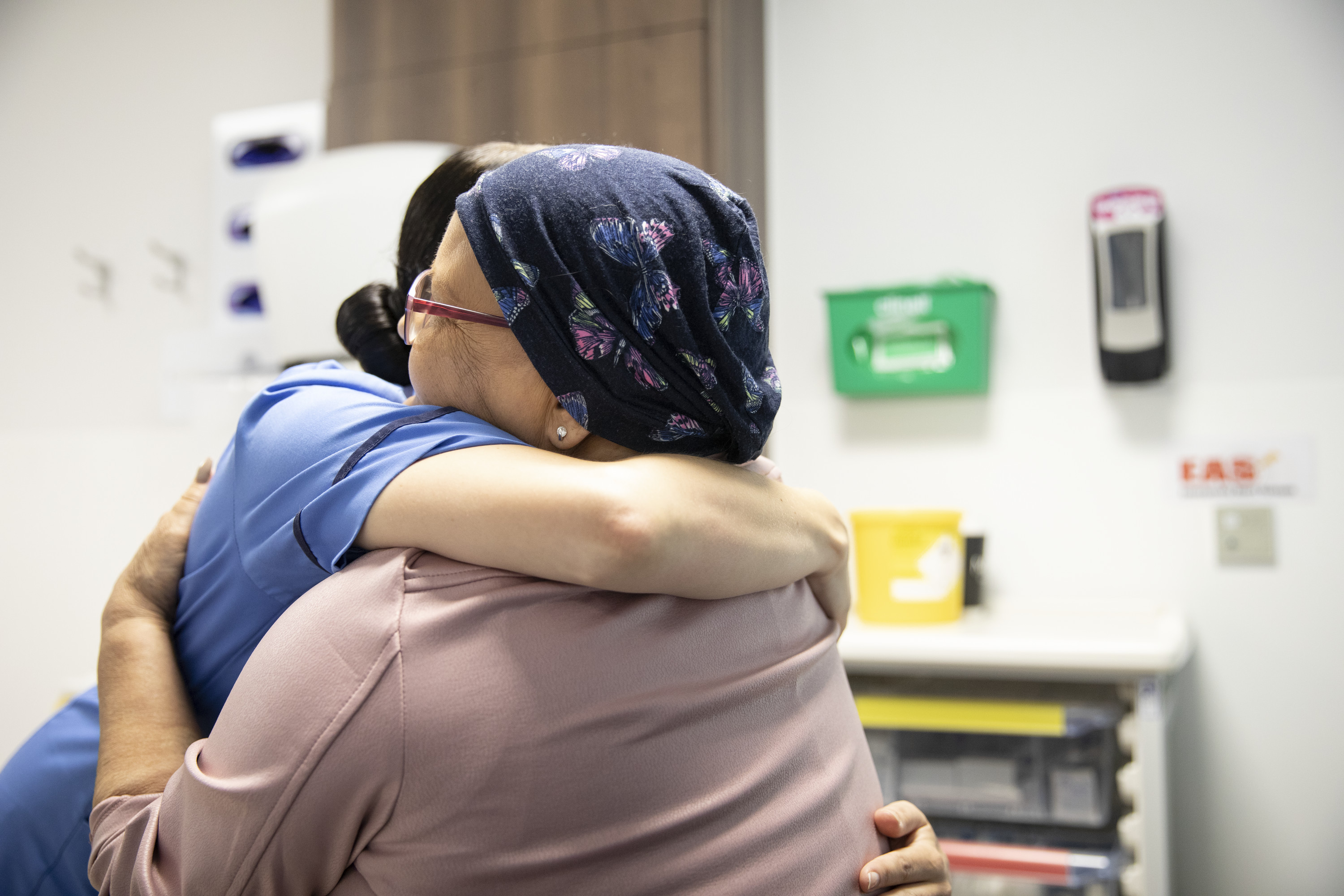 Women hugging Macmillan professional - About us