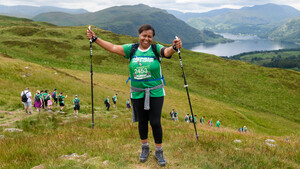 A Macmillan hiker posing for the camera in front of the lakes