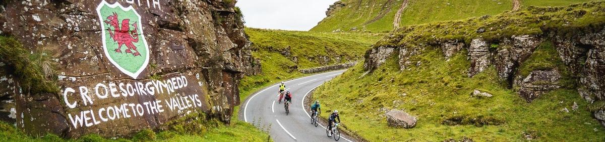 A landscape image of cyclists riding through the Breacon Beacons at the Dragon Ride event.