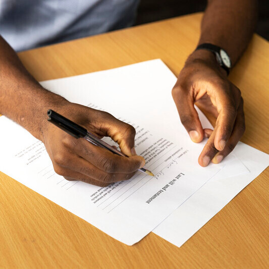 A man signing a form