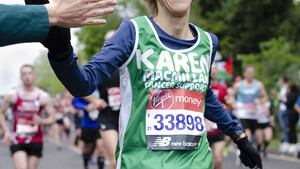 A woman wearing a Macmillan running shirt at Virgin London Marathon 2020