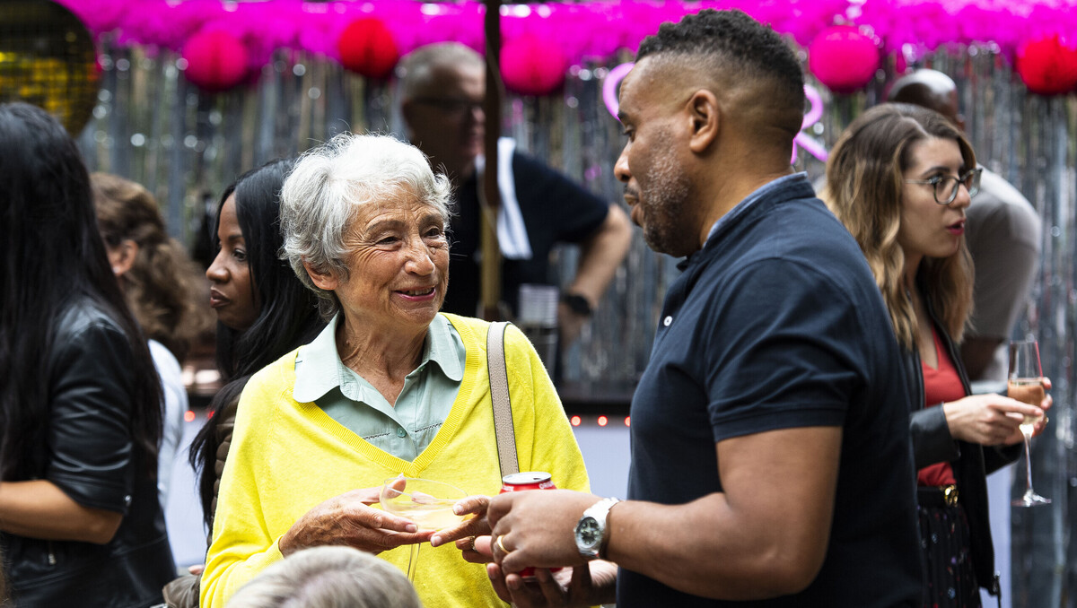A woman and a man chatting at a Coffee Morning