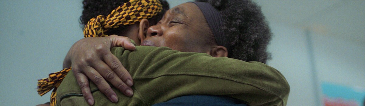 Two black women hugging