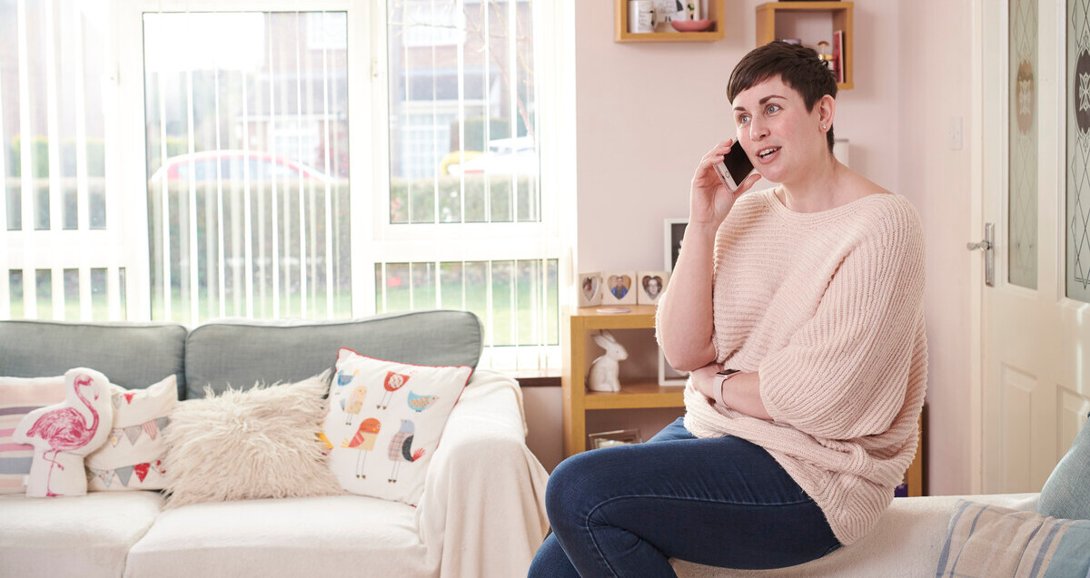 A woman talking on the phone in her home