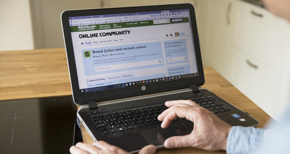 A man looking at the Online Community website from his laptop.