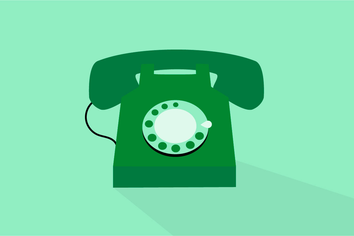 A dark green rotary phone on a light green background.