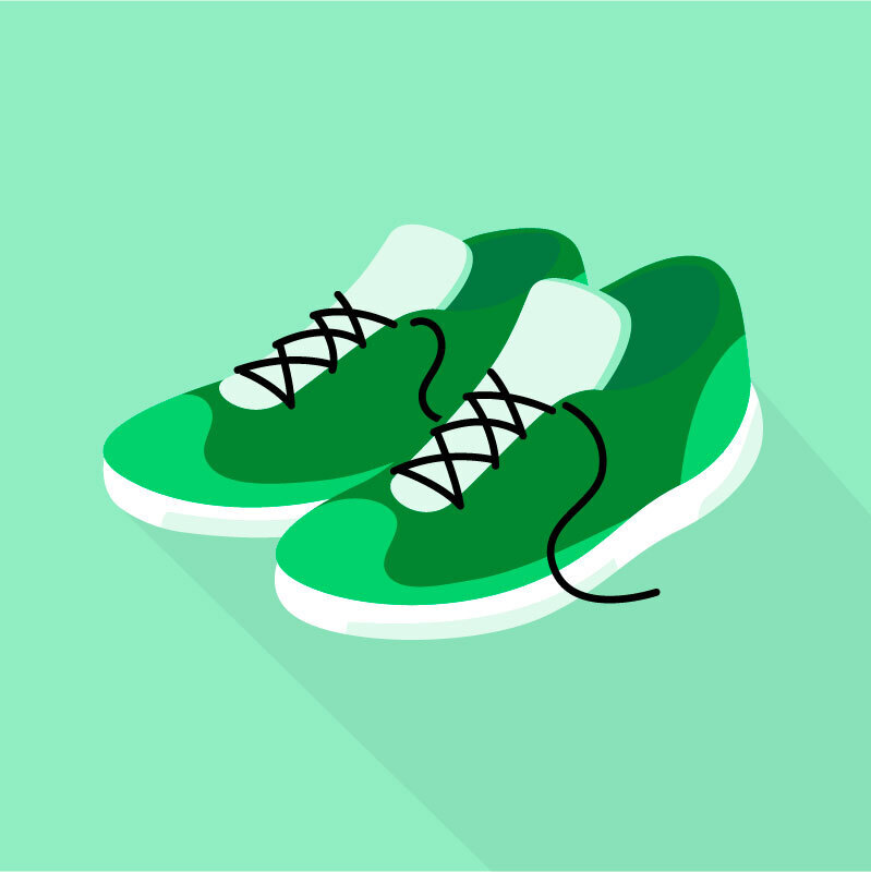 Dark green training shoes on a light green background.