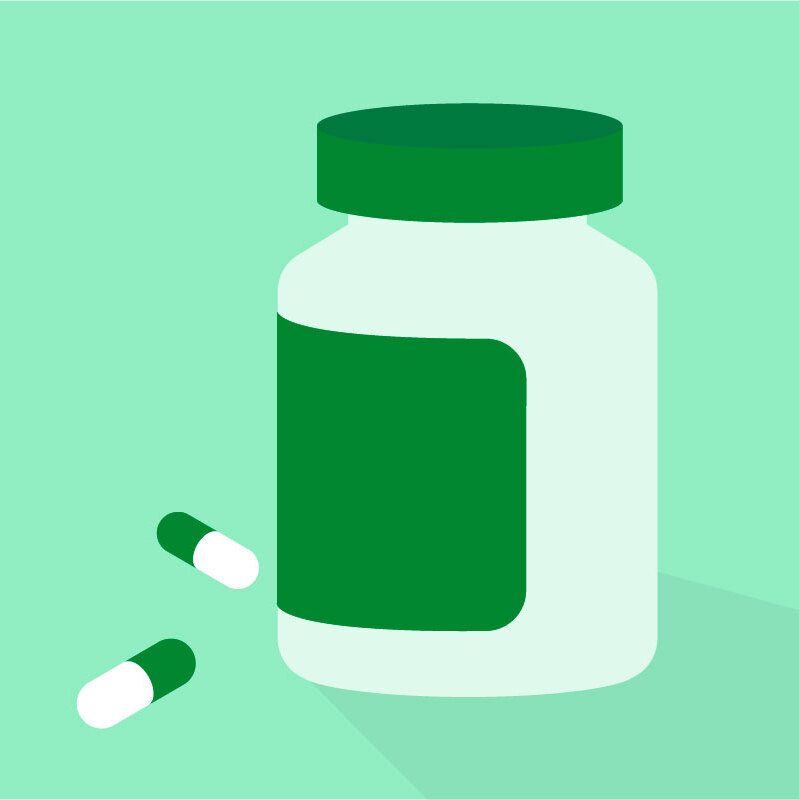 A plastic container for pills with two capsules on a light green background.